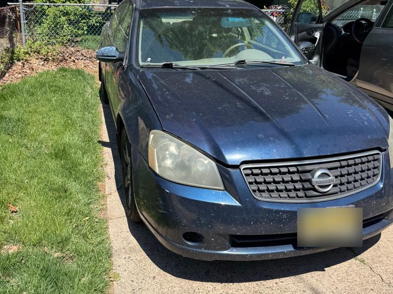 Blue Nissan Altima in a driveway bought by Try Auto Way, car buyer in Princeton NJ